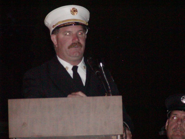 Fire Chief John Chambers addresses the crowd gathered for the 100th Anniversary & Housing